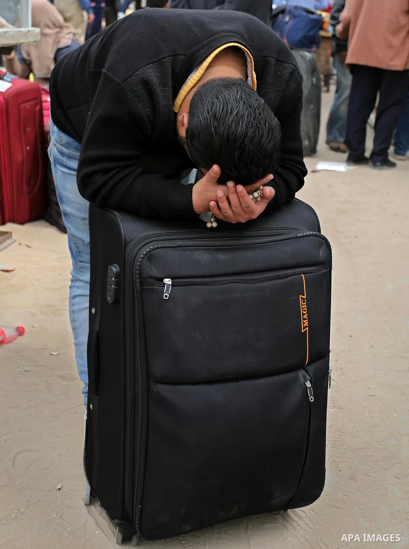 Palestinians wait for travel permits to cross into Egypt through the Rafah border crossing after it was opened by Egyptian authorities for humanitarian cases, in Khan Yunis in the southern Gaza Strip on March 24, 2018. P...