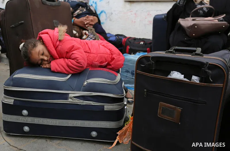 Palestinians wait for travel permits to cross into Egypt through the Rafah border crossing after it was opened by Egyptian authorities for humanitarian cases, in Khan Yunis in the southern Gaza Strip on March 24, 2018. P...