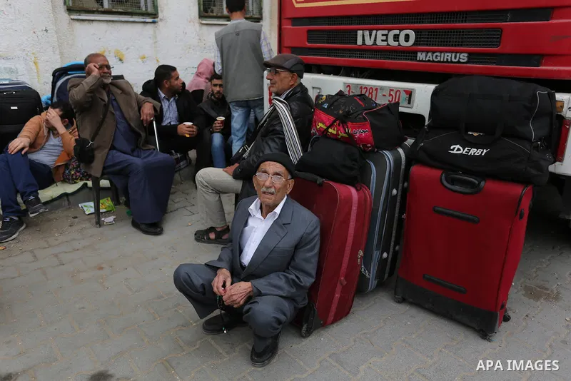 Palestinians wait for travel permits to cross into Egypt through the Rafah border crossing after it was opened by Egyptian authorities for humanitarian cases, in Khan Yunis in the southern Gaza Strip on March 24, 2018. P...