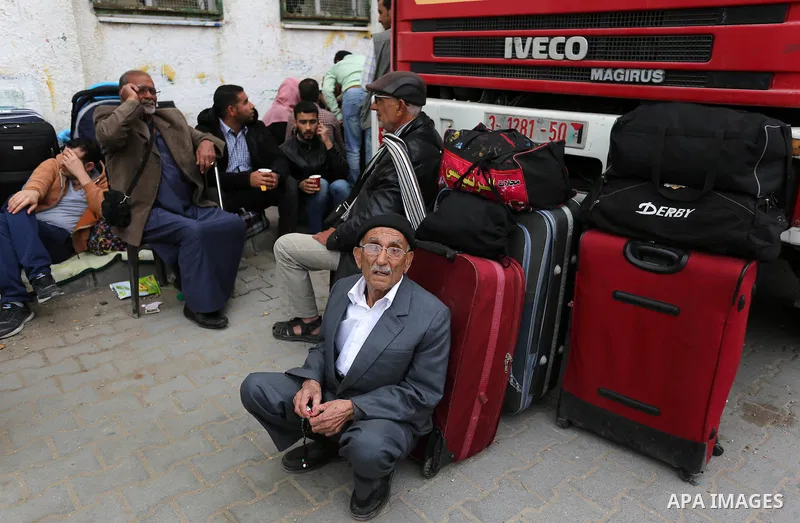 Palestinians wait for travel permits to cross into Egypt through the Rafah border crossing after it was opened by Egyptian authorities for humanitarian cases, in Khan Yunis in the southern Gaza Strip on March 24, 2018. P...