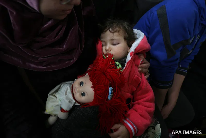 Palestinians wait for travel permits to cross into Egypt through the Rafah border crossing after it was opened by Egyptian authorities for humanitarian cases, in Khan Yunis in the southern Gaza Strip on March 24, 2018. P...