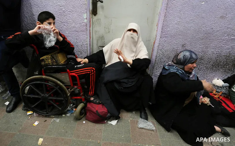 Palestinians wait for travel permits to cross into Egypt through the Rafah border crossing after it was opened by Egyptian authorities for humanitarian cases, in Khan Yunis in the southern Gaza Strip on March 24, 2018. P...