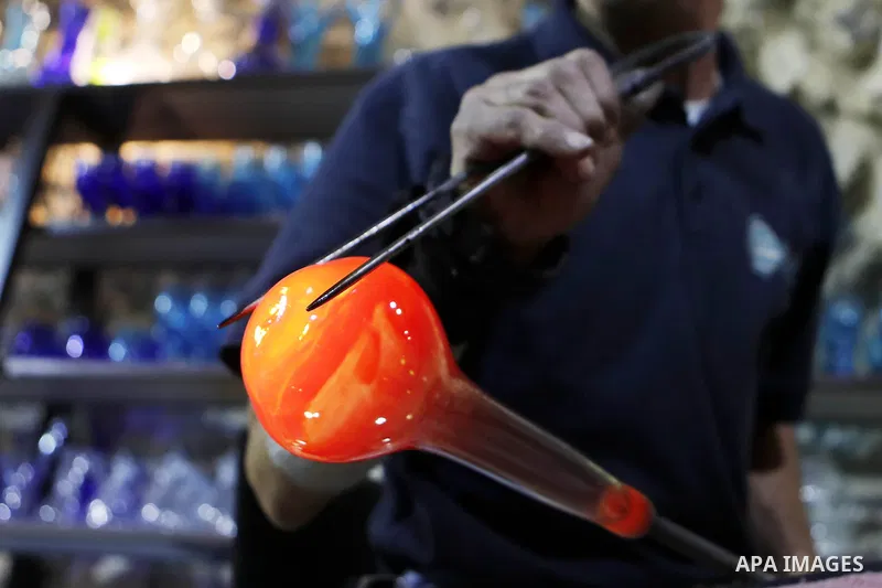 A Palestinian Yaacqoub al-Natsheh, professional glassblower who has been forming glass for over 40 years, works at his new workshop near the Ibrahimi Mosque, in the West Bank city of Hebron, March 25, 2018. Photo by Wisa...