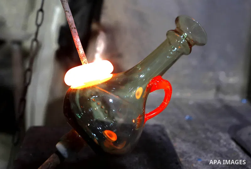 A Palestinian Yaacqoub al-Natsheh, professional glassblower who has been forming glass for over 40 years, works at his new workshop near the Ibrahimi Mosque, in the West Bank city of Hebron, March 25, 2018. Photo by Wisa...