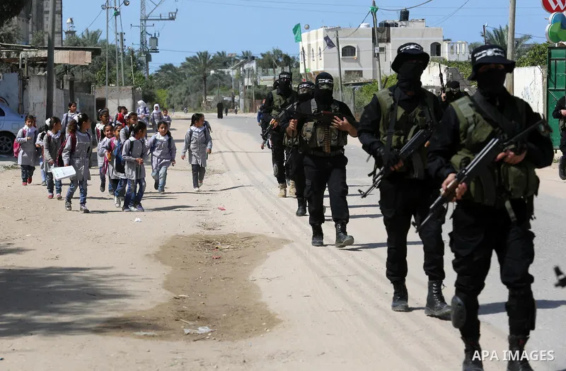 Members of Hamas' armed wing al-Qassam Brigades take Part in a military drill at al-Nusairat refugee camp in the central Gaza Strip, on March 25, 2018. Photo by Ashraf Amra