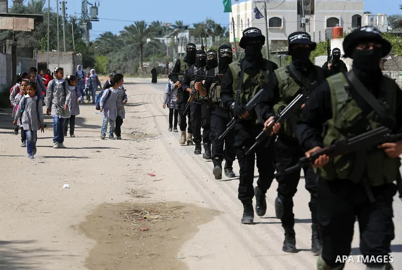 Members of Hamas' armed wing al-Qassam Brigades take Part in a military drill at al-Nusairat refugee camp in the central Gaza Strip, on March 25, 2018. Photo by Ashraf Amra