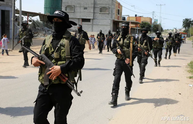 Members of Hamas' armed wing al-Qassam Brigades take Part in a military drill at al-Nusairat refugee camp in the central Gaza Strip, on March 25, 2018. Photo by Ashraf Amra