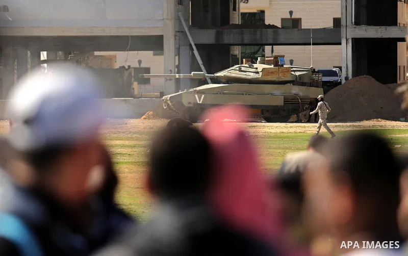 Palestinians watch a life-size model of an Israeli Merkava tank during a military drill of Hamas' armed wing al-Qassam Brigades in Gaza city on March 25, 2018. Photo by Ashraf Amra