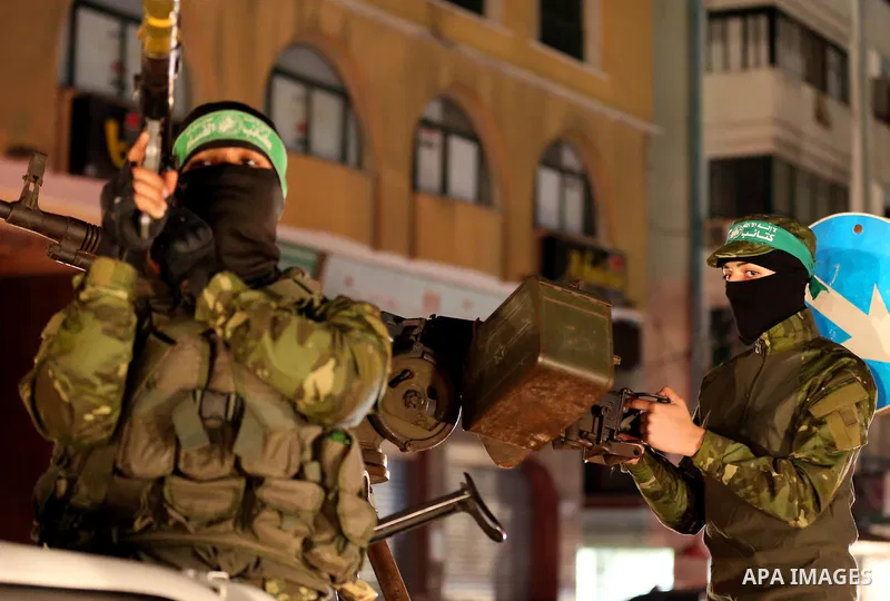 Members of Hamas' armed wing al-Qassam Brigades hold their weapons during a military drill in Gaza City, on March 25, 2018. Photo by Mahmoud Ajour