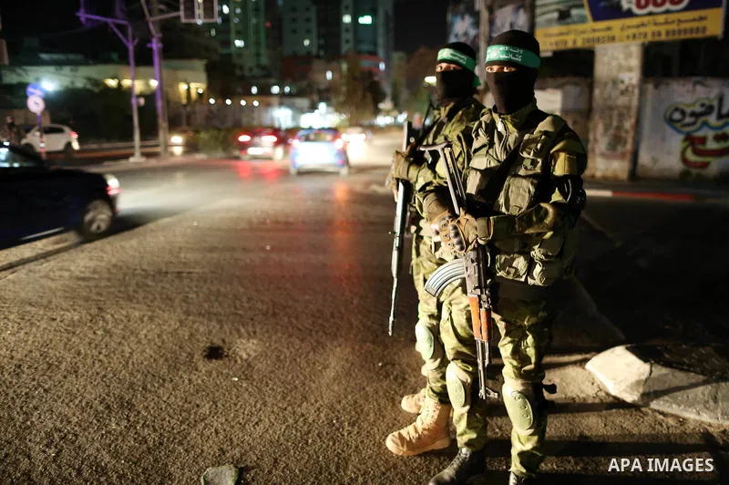 Members of Hamas' armed wing al-Qassam Brigades hold their weapons during a military drill in Gaza City, on March 25, 2018. Photo by Mahmoud Ajour