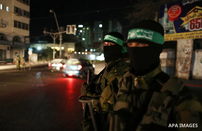 Members of Hamas' armed wing al-Qassam Brigades hold their weapons during a military drill in Gaza City, on March 25, 2018. Photo by Mahmoud Ajour