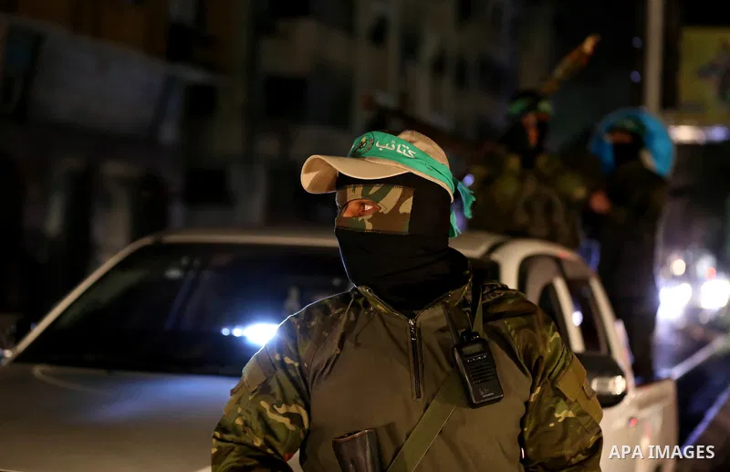 Members of Hamas' armed wing al-Qassam Brigades hold their weapons during a military drill in Gaza City, on March 25, 2018. Photo by Mahmoud Ajour