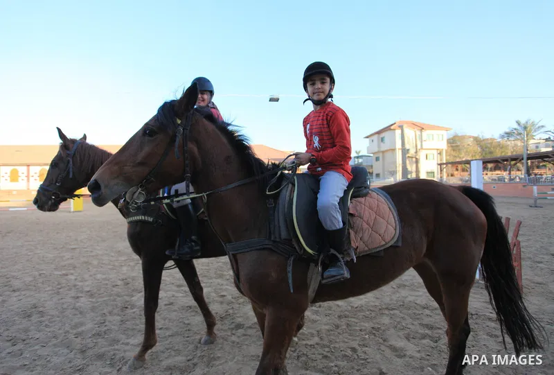 Palestinians ride horses during a training in preparation of equestrian competition in Gaza city on March 26, 2018. Photo by Mahmoud Ajour