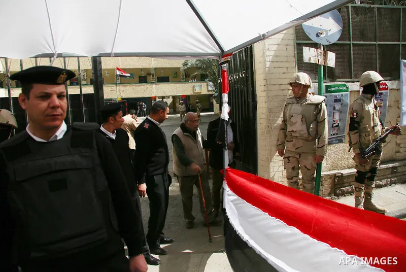 Egypitan security forces stand guard on the first day of the 2018 Egyptian presidential elections, outside a polling station, in Cairo, Egypt, on March 26, 2018. Egyptians head to the polls in a three-day vote to choose...