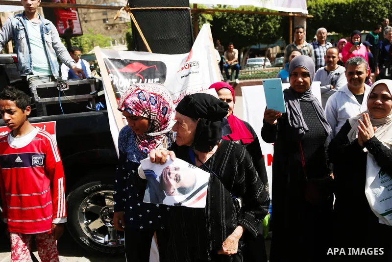 Egyptians celebrate on the first day of the 2018 Egyptian presidential elections, outsdie a polling station, in Cairo, Egypt, on March 26, 2018. Egyptians head to the polls in a three-day vote to choose between incumbent...