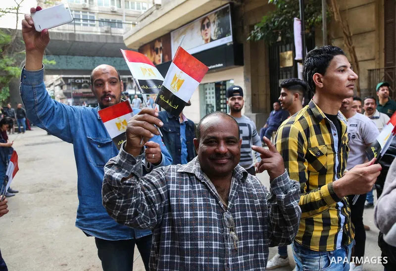 Egyptians celebrate on the first day of the 2018 Egyptian presidential elections, outsdie a polling station, in Cairo, Egypt, on March 26, 2018. Egyptians head to the polls in a three-day vote to choose between incumbent...