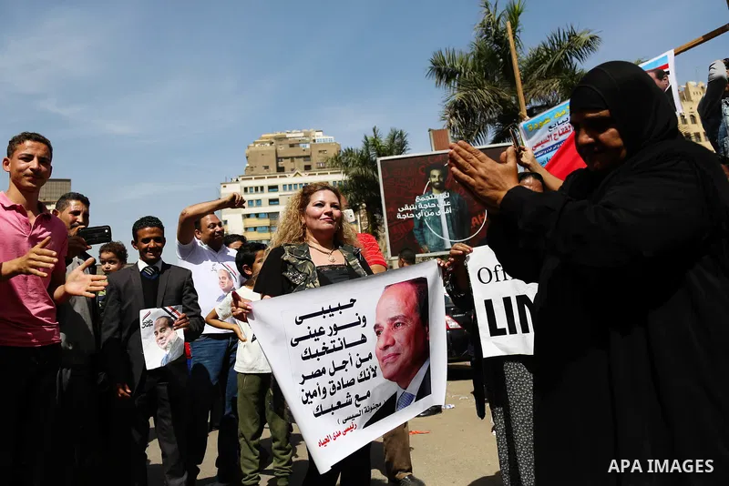 Egyptians celebrate on the first day of the 2018 Egyptian presidential elections, outsdie a polling station, in Cairo, Egypt, on March 26, 2018. Egyptians head to the polls in a three-day vote to choose between incumbent...