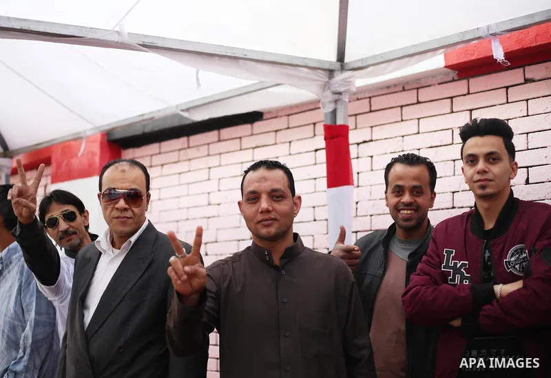 Egyptians celebrate on the first day of the 2018 Egyptian presidential elections, outsdie a polling station, in Cairo, Egypt, on March 26, 2018. Egyptians head to the polls in a three-day vote to choose between incumbent...