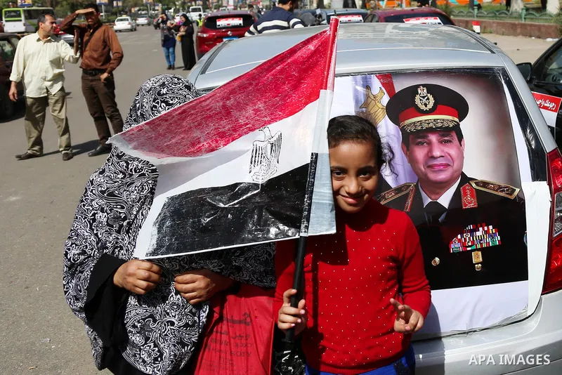 Egyptians celebrate on the first day of the 2018 Egyptian presidential elections, outsdie a polling station, in Cairo, Egypt, on March 26, 2018. Egyptians head to the polls in a three-day vote to choose between incumbent...