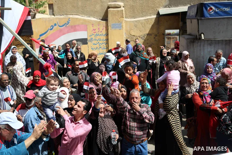 Egyptians celebrate on the first day of the 2018 Egyptian presidential elections, outsdie a polling station, in Cairo, Egypt, on March 26, 2018. Egyptians head to the polls in a three-day vote to choose between incumbent...