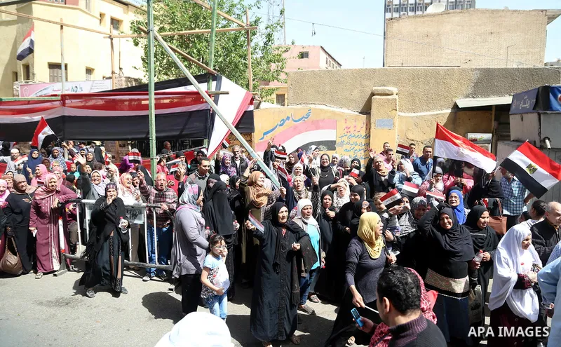 Egyptians celebrate on the first day of the 2018 Egyptian presidential elections, outsdie a polling station, in Cairo, Egypt, on March 26, 2018. Egyptians head to the polls in a three-day vote to choose between incumbent...