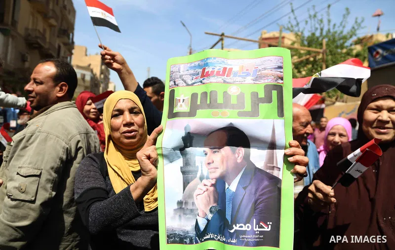 Egyptians celebrate on the first day of the 2018 Egyptian presidential elections, outsdie a polling station, in Cairo, Egypt, on March 26, 2018. Egyptians head to the polls in a three-day vote to choose between incumbent...