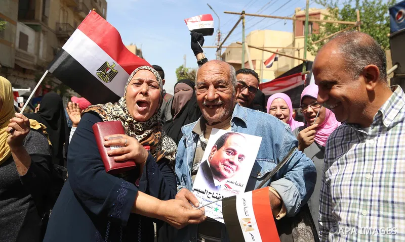 Egyptians celebrate on the first day of the 2018 Egyptian presidential elections, outsdie a polling station, in Cairo, Egypt, on March 26, 2018. Egyptians head to the polls in a three-day vote to choose between incumbent...