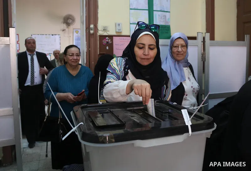 An Egyptian woman casts her vote on the first day of the 2018 Egyptian presidential elections, at a polling station, in Cairo, Egypt, on March 26, 2018. Egyptians head to the polls in a three-day vote to choose between i...