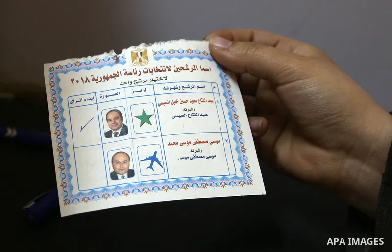 An Egyptian voter holds a ballot paper on the first day of the 2018 Egyptian presidential elections, at a polling station, in Cairo, Egypt, on March 26, 2018. Egyptians head to the polls in a three-day vote to choose bet...