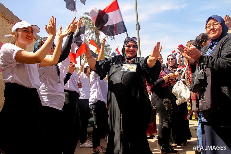 Egyptians celebrate on the first day of the 2018 Egyptian presidential elections, outsdie a polling station, in Cairo, Egypt, on March 26, 2018. Egyptians head to the polls in a three-day vote to choose between incumbent...