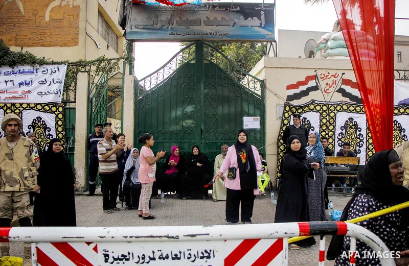 Egyptians celebrate on the first day of the 2018 Egyptian presidential elections, outsdie a polling station, in Cairo, Egypt, on March 26, 2018. Egyptians head to the polls in a three-day vote to choose between incumbent...