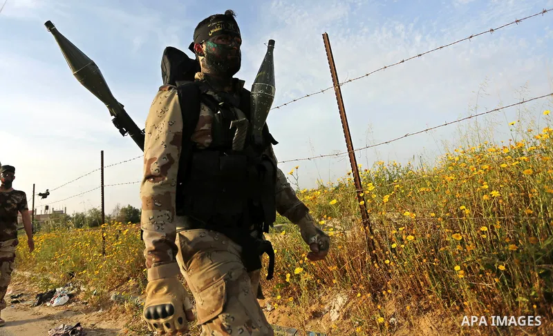 Palestinian Islamic Jihad militants march during a military drill in Khan Yunis in the southern Gaza Strip March 27, 2018. Photo by Ashraf Amra