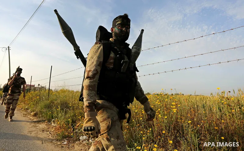 Palestinian Islamic Jihad militants march during a military drill in Khan Yunis in the southern Gaza Strip March 27, 2018. Photo by Ashraf Amra