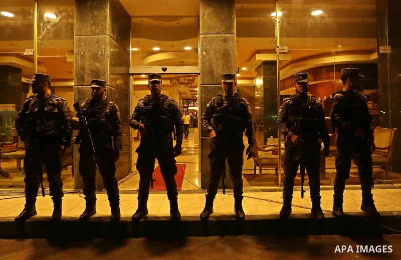 Palestinian police men stand guard during a press conference held by Iyad al-Bozum, an interior ministry spokesman in Gaza Strip about the investigations of an explosion that targeted the convoy of Palestinian Prime Mini...