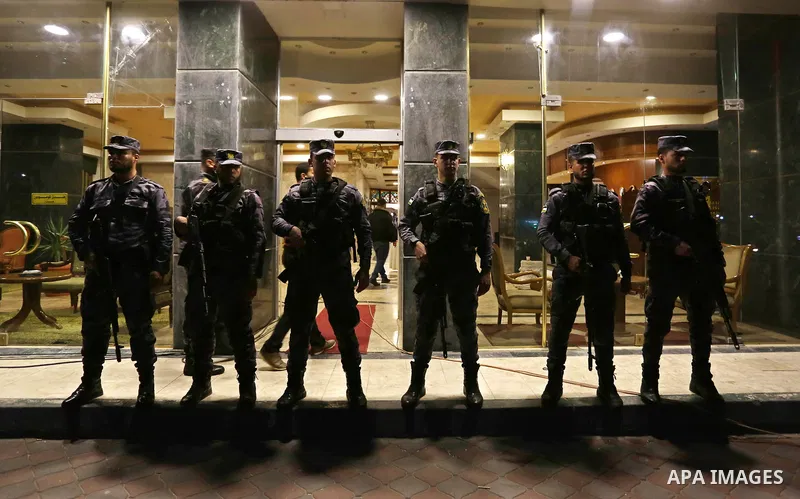 Palestinian police men stand guard during a press conference held by Iyad al-Bozum, an interior ministry spokesman in Gaza Strip about the investigations of an explosion that targeted the convoy of Palestinian Prime Mini...