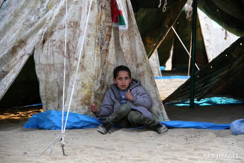 Paleatinians gather next to tents pitched by Palestinians on the Gaza border with Israel, east of Jabalia, on March 29, 2018, ahead of a six-week protest camp. The exceptional protest is dubbed "The Great March of Return...