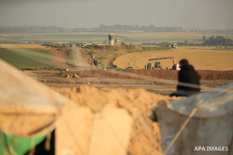 Paleatinians gather next to tents pitched by Palestinians on the Gaza border with Israel, east of Jabalia, on March 29, 2018, ahead of a six-week protest camp. The exceptional protest is dubbed "The Great March of Return...