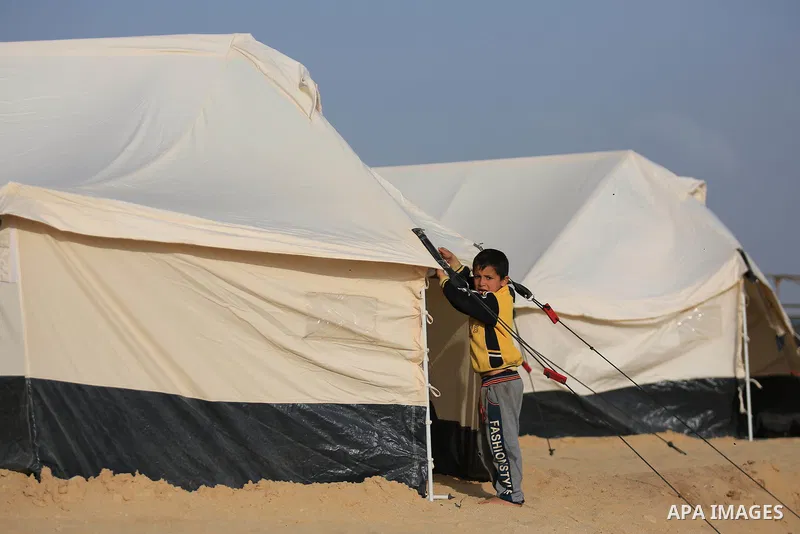 Paleatinians gather next to tents pitched by Palestinians on the Gaza border with Israel, east of Jabalia, on March 29, 2018, ahead of a six-week protest camp. The exceptional protest is dubbed "The Great March of Return...