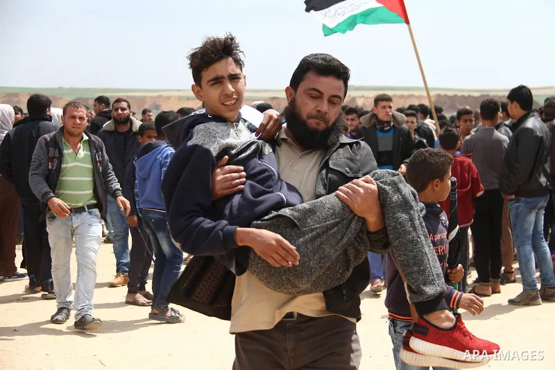 A wounded Palestinian is evacuated during clashes with Israeli security forces, during a tent city protest along the Israel border with Gaza, demanding the right to return to their homeland, east of Jabalia, in the north...