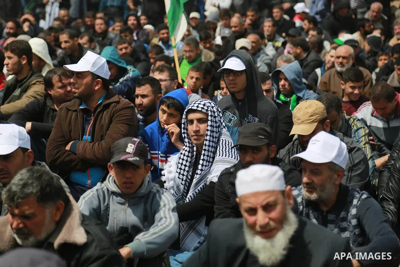Palestinian Muslim worshippers perform Friday noon prayers during a tent city protest along the Israel border with Gaza, demanding the right to return to their homeland, east of Gaza City March 30, 2018. Photo by Mohamme...