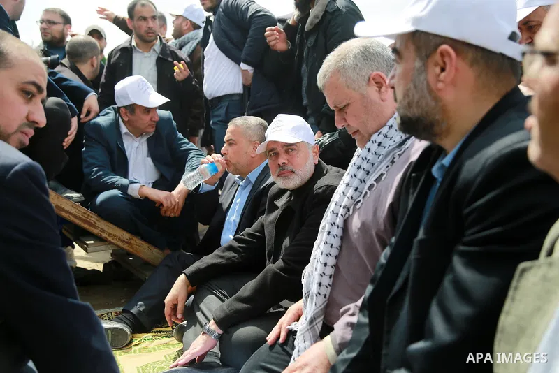 Hamas chief Ismail Haniyeh performs Friday noon prayers during a tent city protest along the Israel border with Gaza, demanding the right to return to their homeland, east of Gaza City March 30, 2018. Photo by Mohammed D...