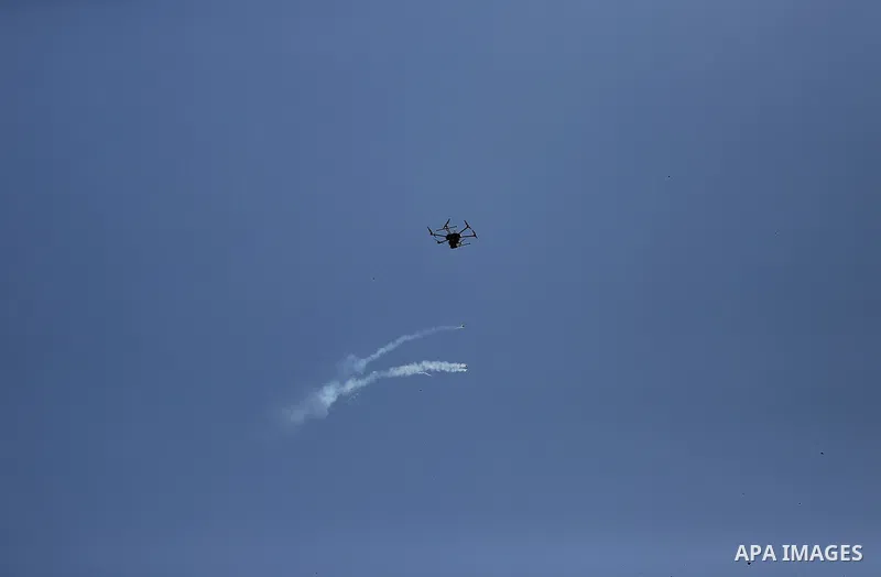 An Israeli drone drops tear gas grenades during clashes with Palestinians, in a tent city protest along the Israel border with Gaza, demanding the right to return to their homeland, east of Gaza City March 30, 2018. Phot...