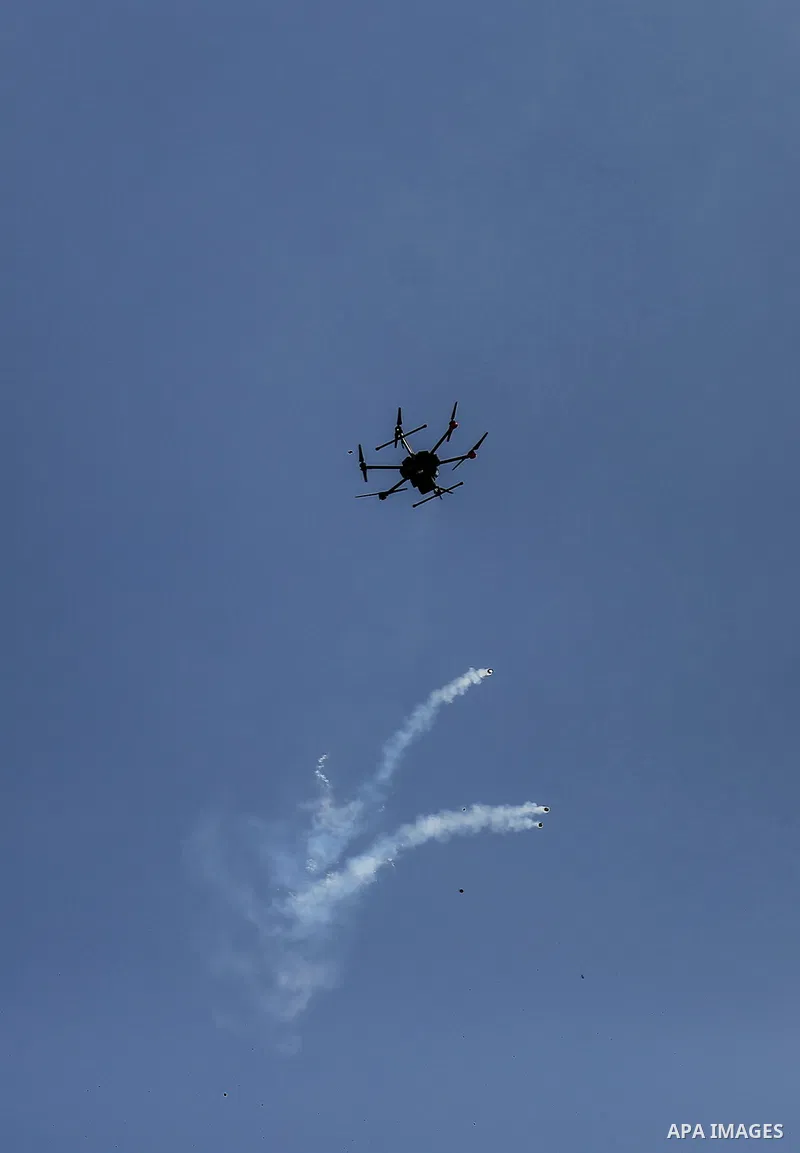 An Israeli drone drops tear gas grenades during clashes with Palestinians, in a tent city protest along the Israel border with Gaza, demanding the right to return to their homeland, east of Gaza City March 30, 2018. Phot...