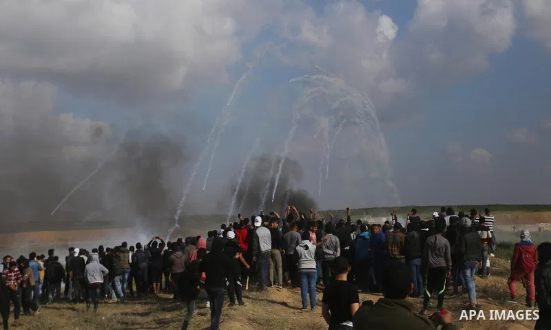 Palestinian protesters clash with Israeli security forces in a tent city protest at along the Israel border with Gaza, demanding the right to return to their homeland, in al-Bureij in the center of Gaza strip on March 30...