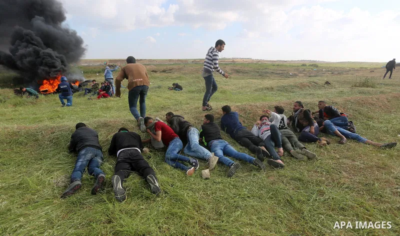 Palestinian protesters clash with Israeli security forces in a tent city protest at along the Israel border with Gaza, demanding the right to return to their homeland, in al-Bureij in the center of Gaza strip on March 30...