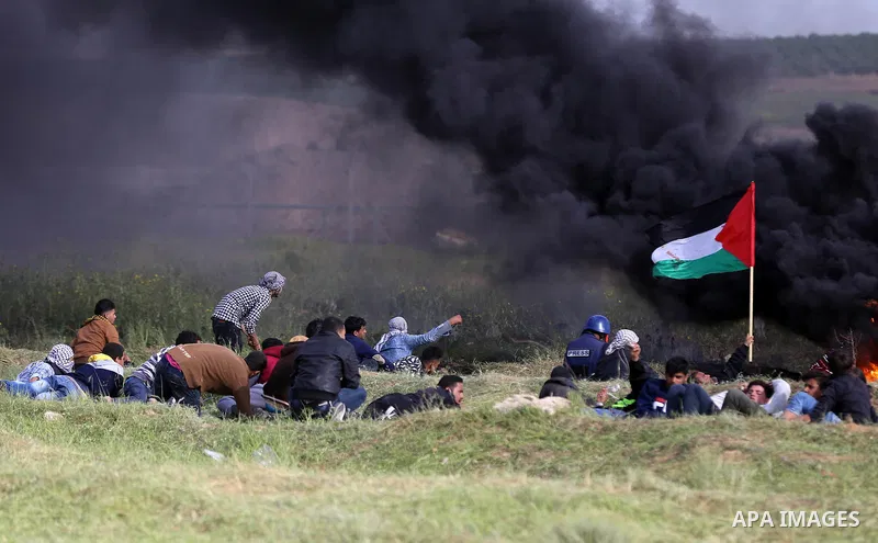 Palestinian protesters clash with Israeli security forces in a tent city protest at along the Israel border with Gaza, demanding the right to return to their homeland, in al-Bureij in the center of Gaza strip on March 30...