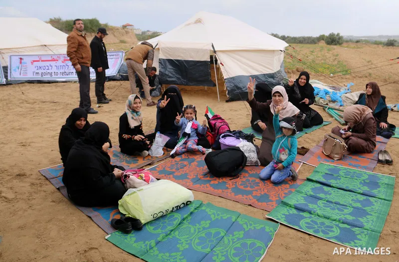 Palestinians take part during a tent city protest along the Israel border with Gaza, demanding the right to return to their homeland, in al-Bureij in the center of Gaza strip on March 30, 2018. Photo by Mahmoud Khattab