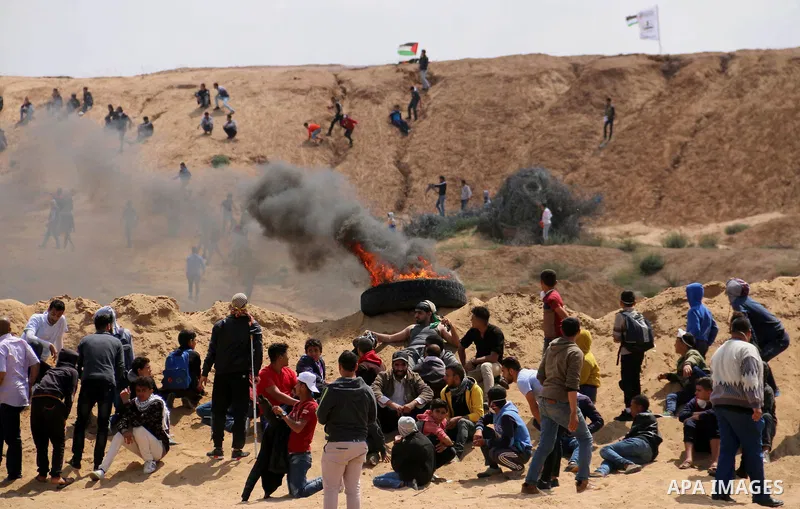 Palestinian protesters clash with Israeli security forces in a tent city protest at along the Israel border with Gaza, demanding the right to return to their homeland, in al-Bureij in the center of Gaza strip on March 30...