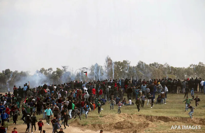 Palestinian protesters clash with Israeli security forces in a tent city protest at along the Israel border with Gaza, demanding the right to return to their homeland, in al-Bureij in the center of Gaza strip on March 30...