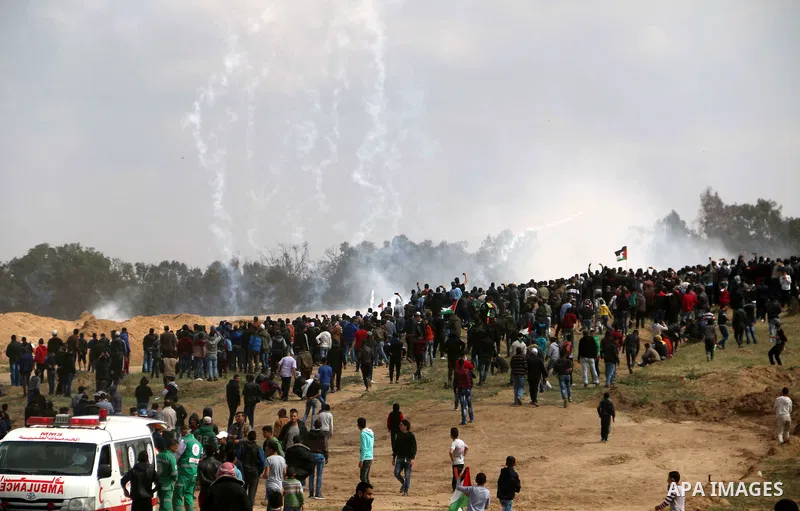 Palestinian protesters clash with Israeli security forces in a tent city protest at along the Israel border with Gaza, demanding the right to return to their homeland, in al-Bureij in the center of Gaza strip on March 30...